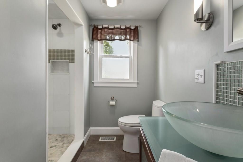 22 Irving Street Reading, MA 01867 - Photo 19 of 37 a bathroom with a toilet and a bathtub