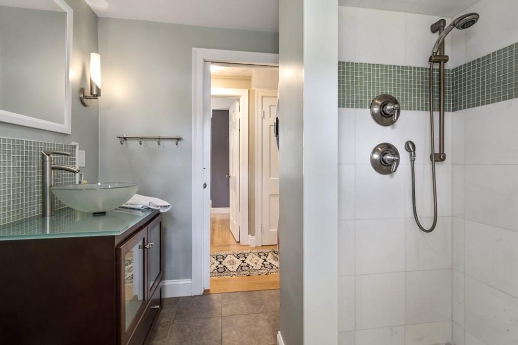 22 Irving Street Reading, MA 01867 - Photo 21 of 37 a bathroom with a granite countertop shower a mirror and sink