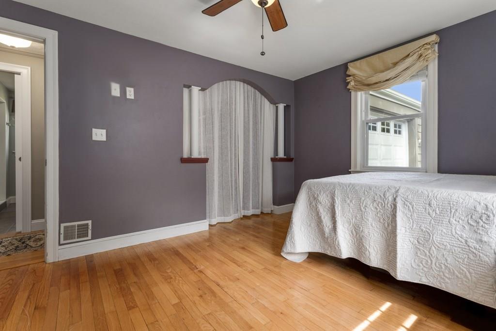 22 Irving Street Reading, MA 01867 - Photo 25 of 37 a bedroom with a bed and a flat screen tv