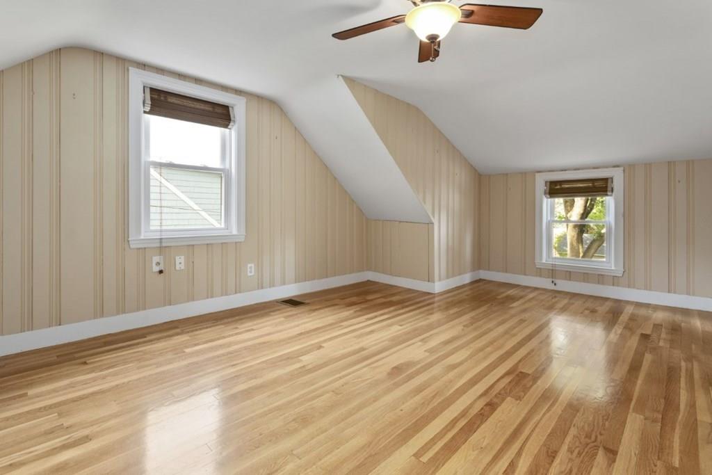 22 Irving Street Reading, MA 01867 - Photo 27 of 37 a view of empty room with wooden floor and fan