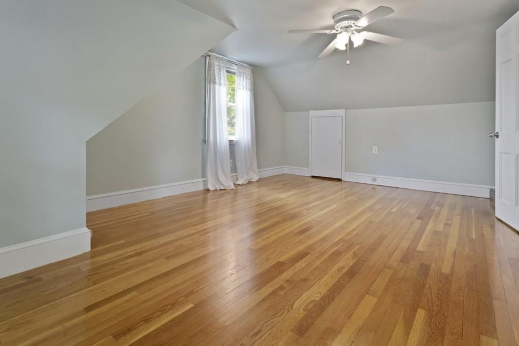 22 Irving Street Reading, MA 01867 - Photo 30 of 37 an empty room with wooden floor closet and windows