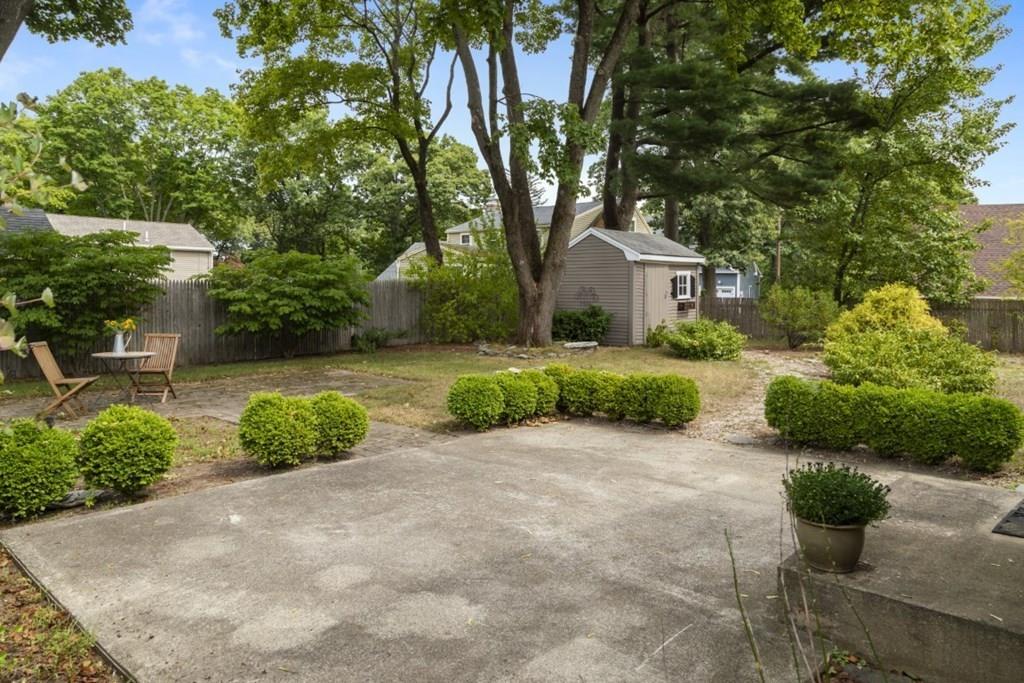 22 Irving Street Reading, MA 01867 - Photo 35 of 37 a view of a house with a yard and potted plants