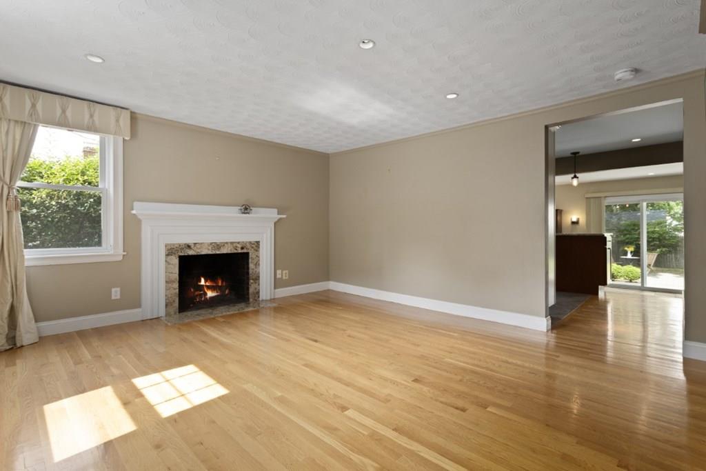 22 Irving Street Reading, MA 01867 - Photo 5 of 37 a view of an empty room with a fireplace and a window