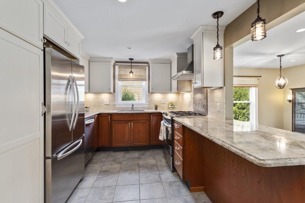 22 Irving Street Reading, MA 01867 - Photo 10 of 37 a kitchen with stainless steel appliances granite countertop a sink stove and refrigerator