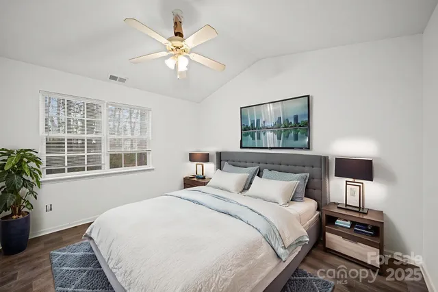 a bedroom with a large bed and a window