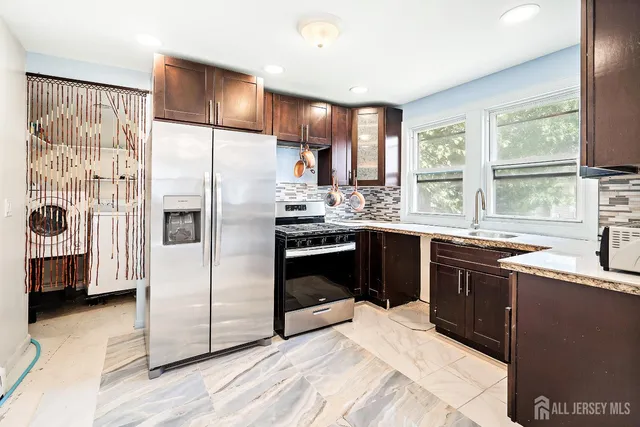 a kitchen with a sink stove and refrigerator