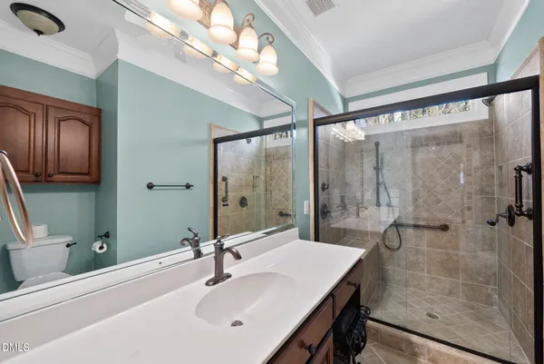 an empty room with wooden floor chandelier fan and windows