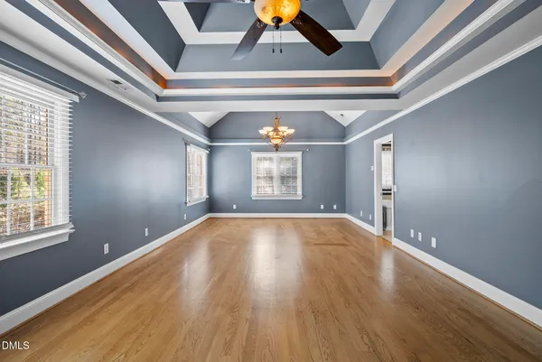 a view of room with window ceiling fan and hardwood floor