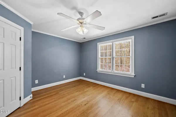 a front view of residential houses with yard and green space