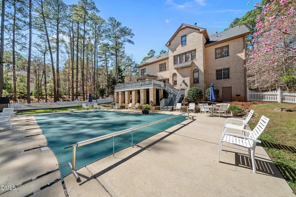an aerial view of a house with yard swimming pool and outdoor seating