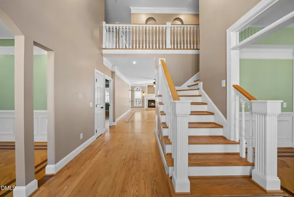 a kitchen with stainless steel appliances granite countertop stove a sink dishwasher and wooden cabinets with wooden floor