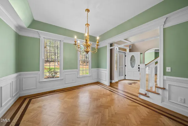 a view of empty room with fireplace and wooden floor