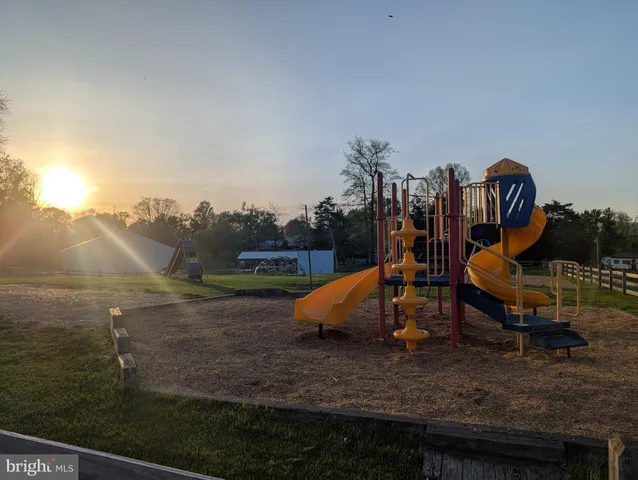 a view of a backyard with swimming pool