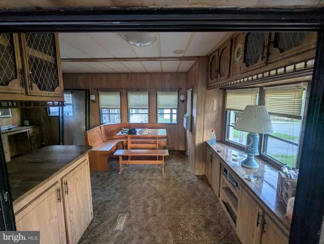 a kitchen with granite countertop a refrigerator and a sink
