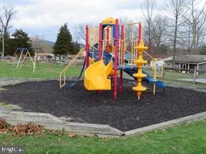 a childrens park with lots of swings and slides