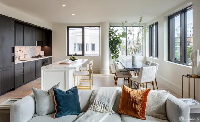 a living room with furniture and large windows