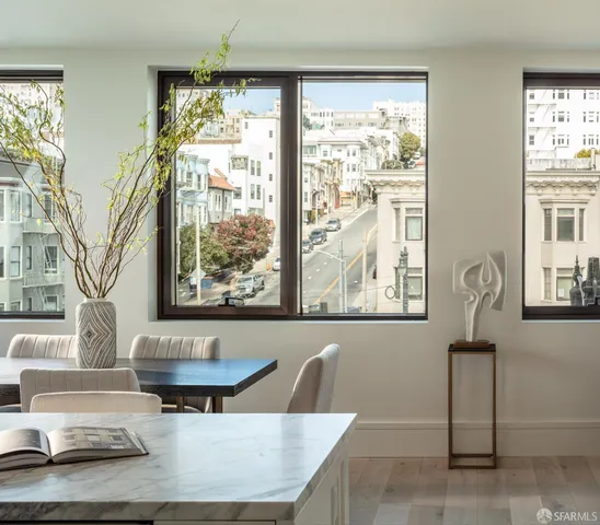a living room with furniture and large windows