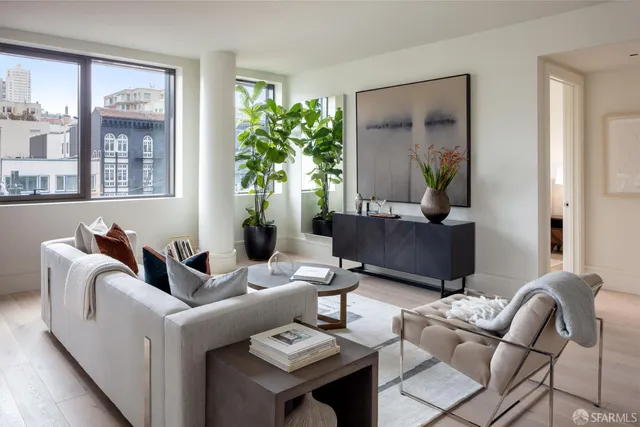 a living room with furniture and a potted plant