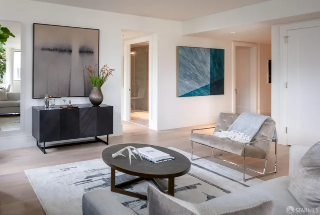 a living room with furniture and a potted plant