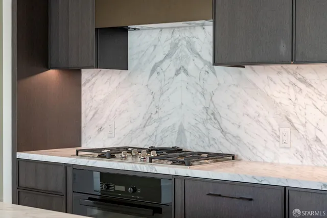 a spacious bedroom with a bed a table and painting