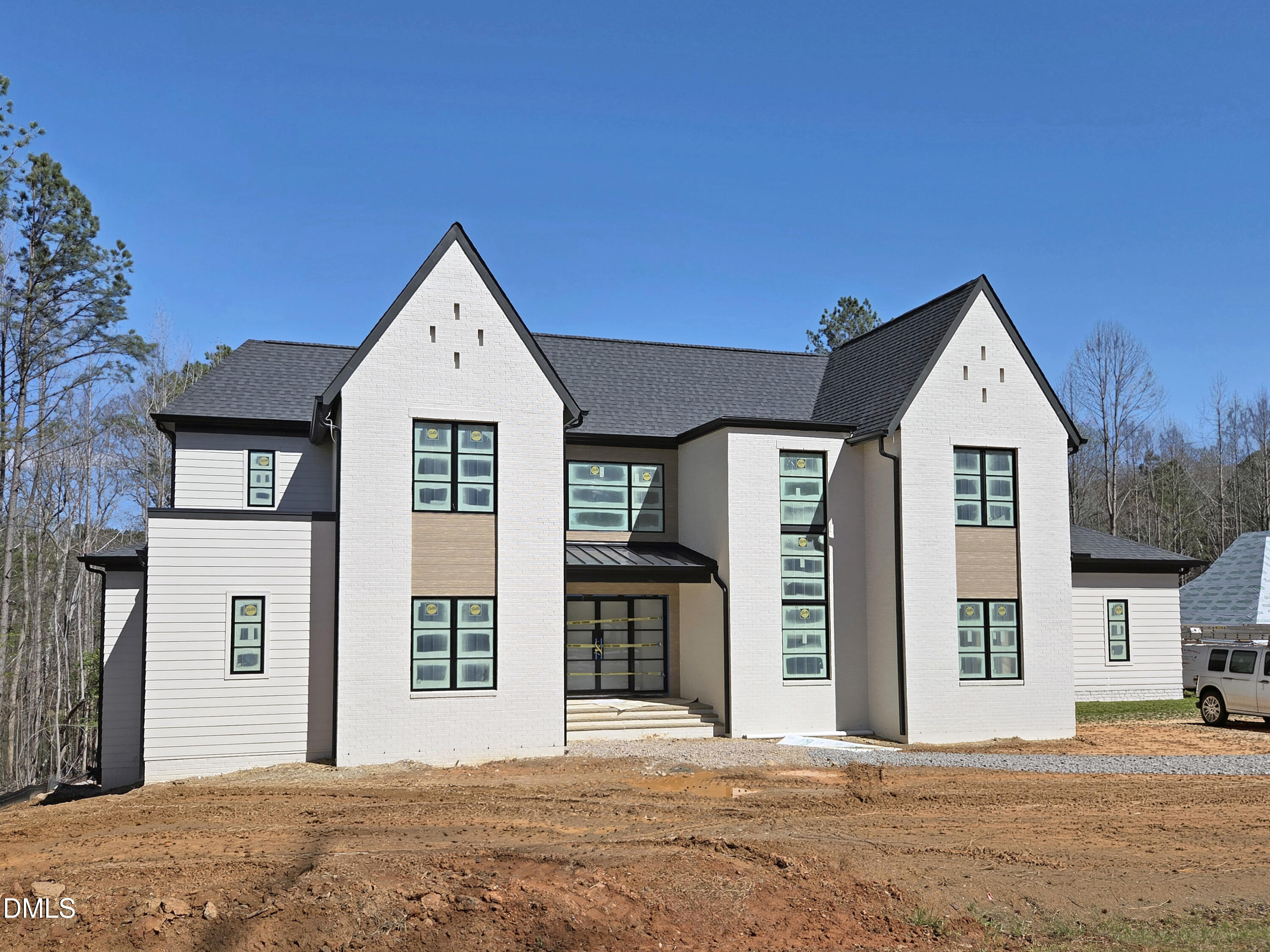 408 Shinleaf Pond Trail Raleigh, NC 27614 - Photo 6 of 77 a front view of a house with glass windows and a yard