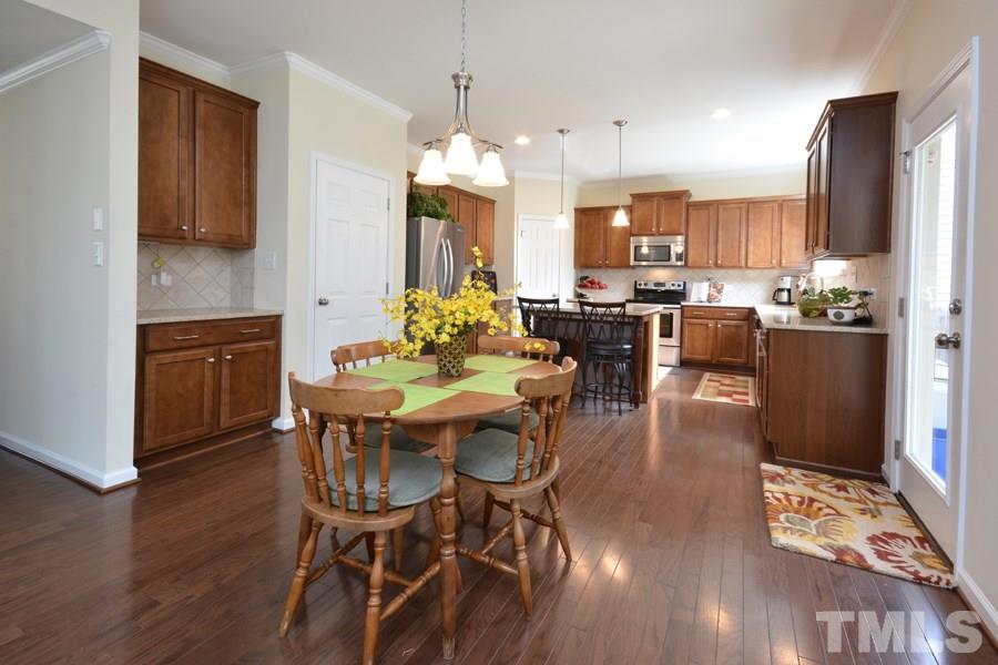 1007 Lakeview Road Durham, NC 27712 - Photo 12 of 25 a view of a dining room with furniture and wooden floor