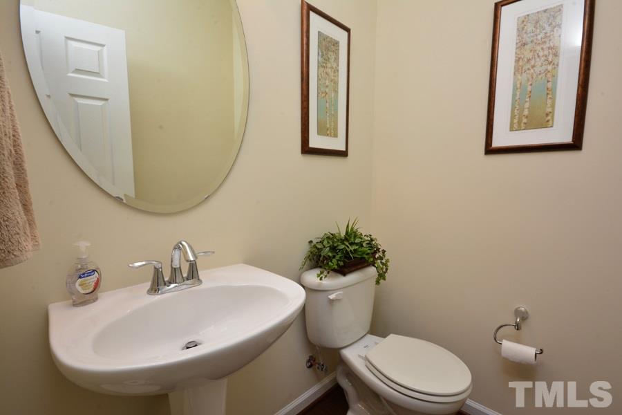 1007 Lakeview Road Durham, NC 27712 - Photo 13 of 25 a white toilet sitting next to a bathroom sink