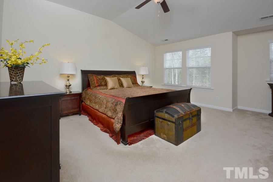 1007 Lakeview Road Durham, NC 27712 - Photo 15 of 25 a bedroom with a bed window and potted plant on table