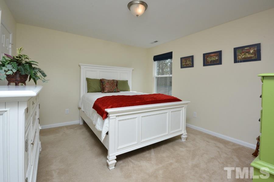 1007 Lakeview Road Durham, NC 27712 - Photo 20 of 25 a bedroom with a bed and a potted plant