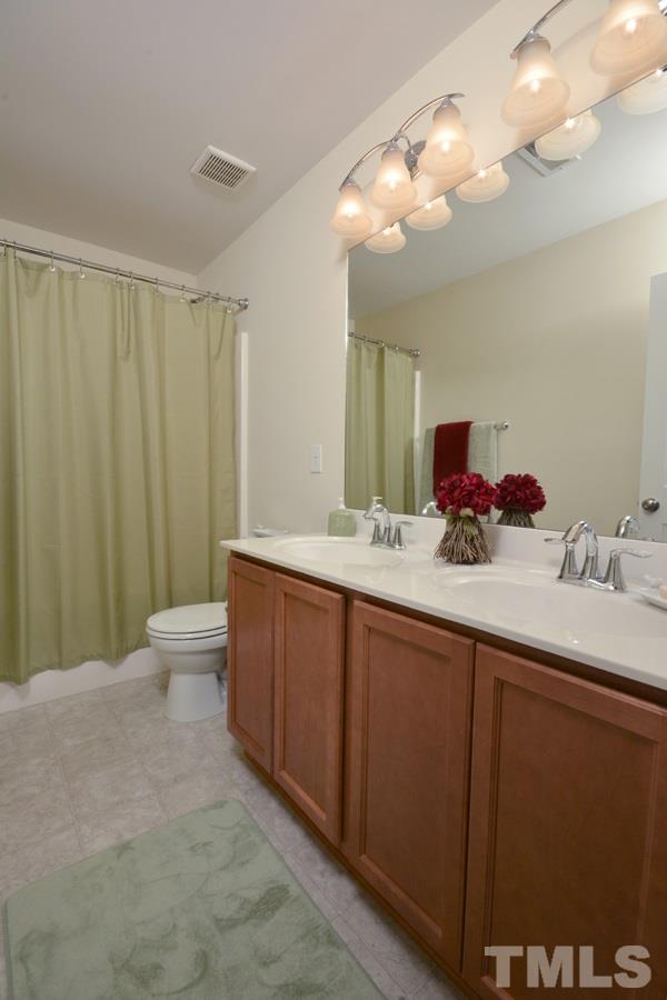 1007 Lakeview Road Durham, NC 27712 - Photo 21 of 25 a bathroom with a double vanity sink and a mirror