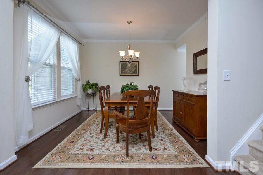 1007 Lakeview Road Durham, NC 27712 - Photo 4 of 25 a dining room with furniture a rug and wooden floor