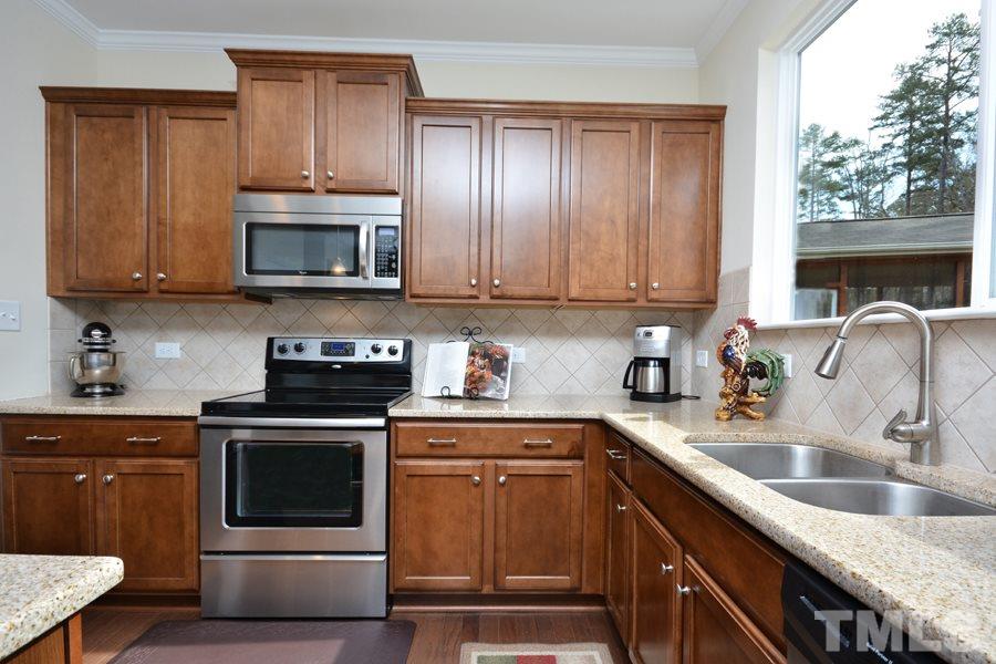 1007 Lakeview Road Durham, NC 27712 - Photo 9 of 25 a kitchen with granite countertop a sink stove and microwave