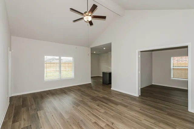 wooden floor in an empty room with a window