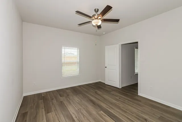 wooden floor in an empty room with a window