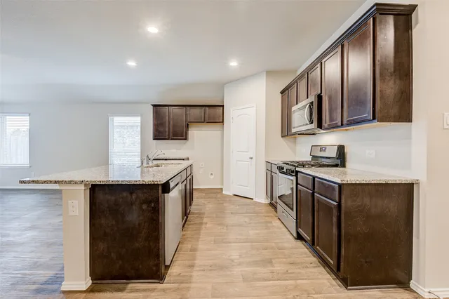 a kitchen with stainless steel appliances cabinets a sink and a stove