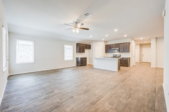 an empty room with windows and a fireplace