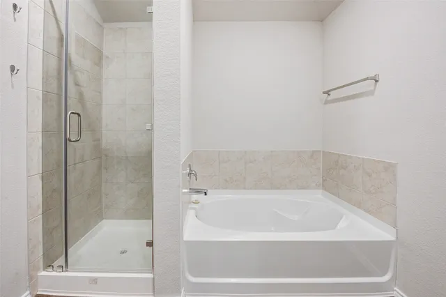 a bathroom with a double vanity sink a mirror and a bathtub