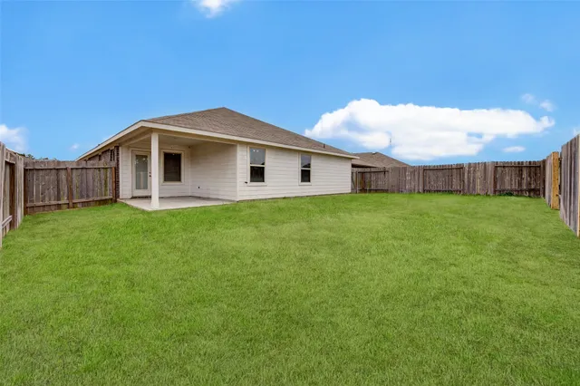 a view of a house with a backyard