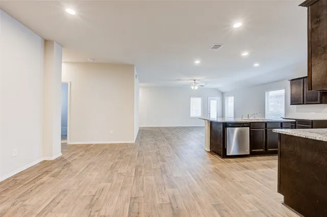 a view of a kitchen with a sink and a refrigerator