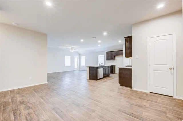 a view of kitchen with microwave oven stove and cabinets