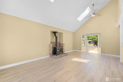an empty room with wooden floor and a window