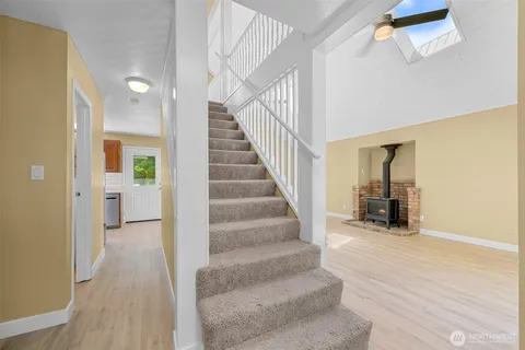 a view of a hallway view with staircase and living room
