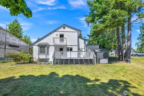 a view of a house with a yard patio and fire pit