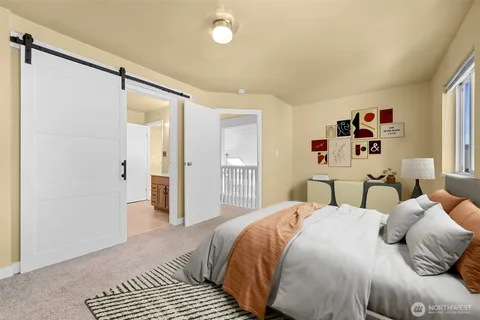 a bedroom with a large bed and a chandelier