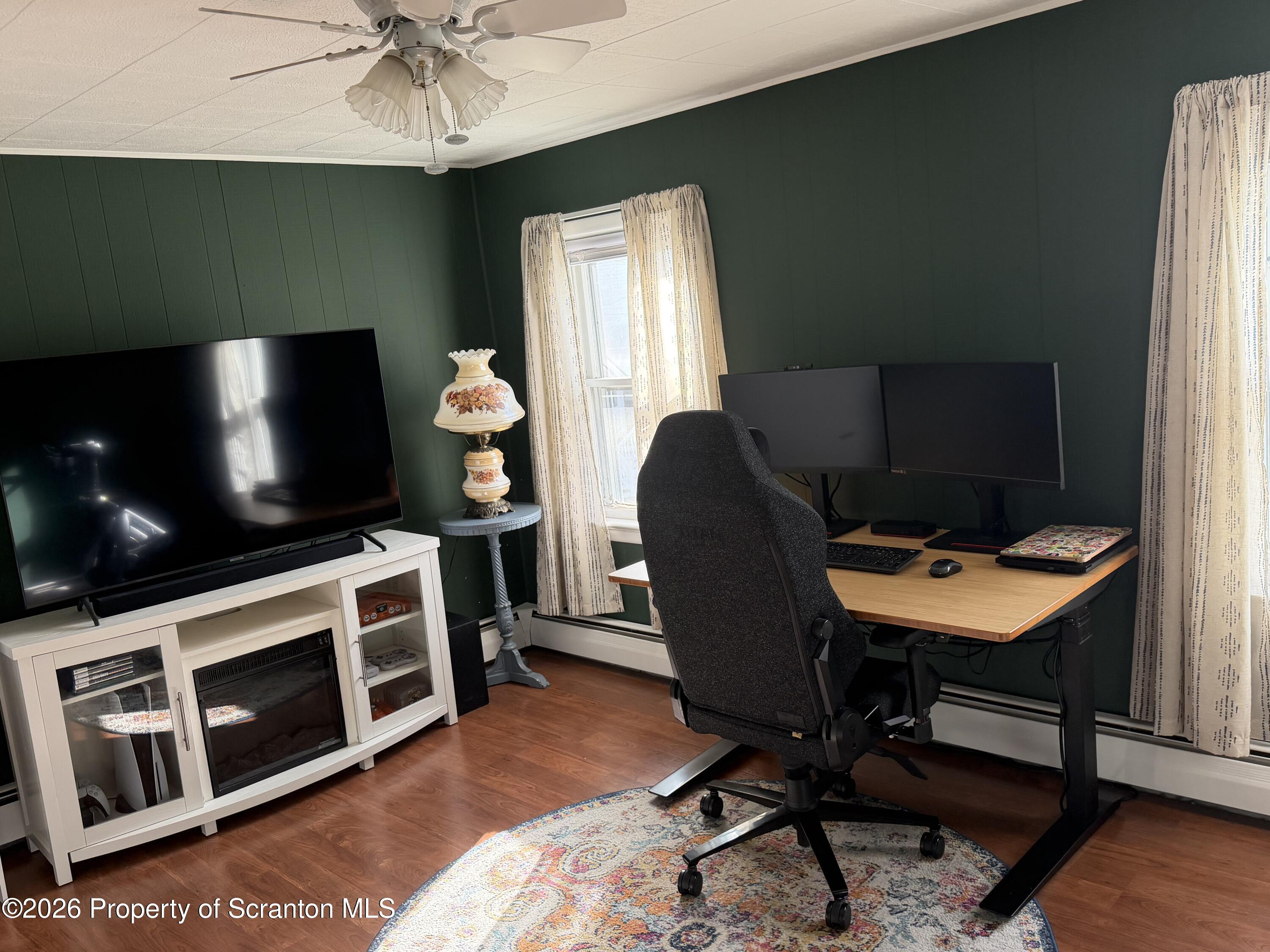 320 Haverly Street Throop, PA 18512 - Photo 17 of 27 a view of a workspace with furniture and a flat screen tv