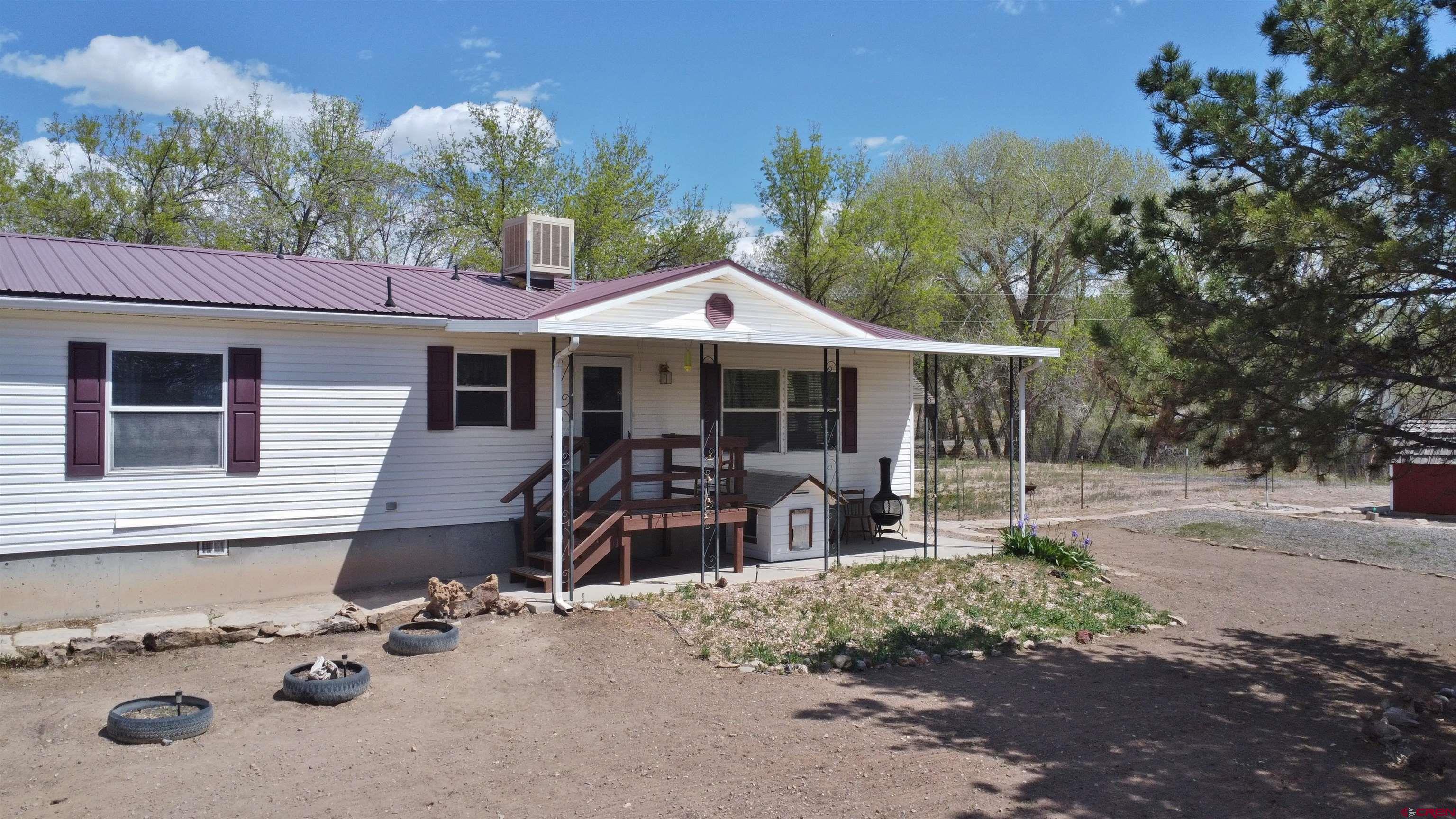 21274 Knight Road Austin, CO 81410 - Photo 2 of 35 a front view of a house with garden