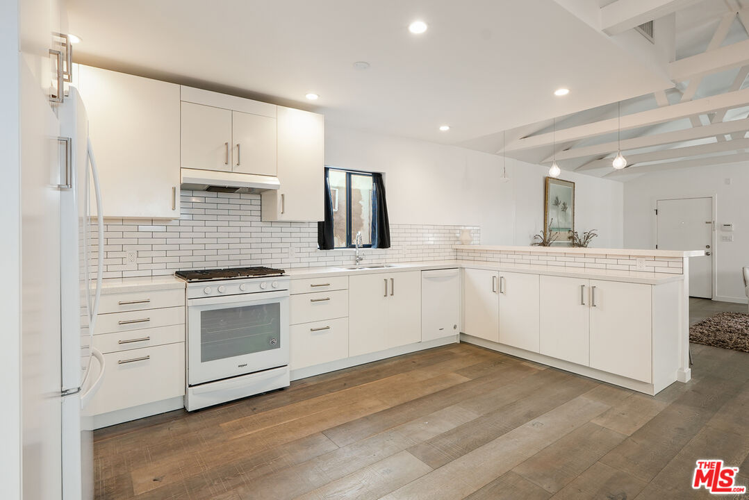 754 Washington Boulevard Marina del Rey, CA 90292 - Photo 4 of 14 a kitchen with white cabinets stainless steel appliances and sink