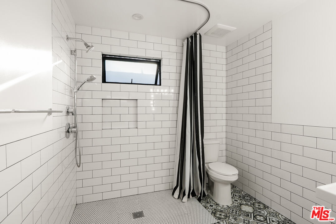 754 Washington Boulevard Marina del Rey, CA 90292 - Photo 8 of 14 a bathroom with a toilet and a shower