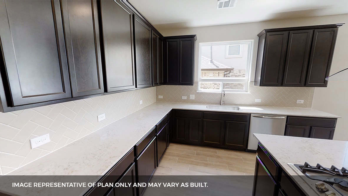 516 Prairie Wind Drive Leander, TX 78641 - Photo 12 of 40 a kitchen with stainless steel appliances kitchen island granite countertop a refrigerator a sink and wooden cabinets
