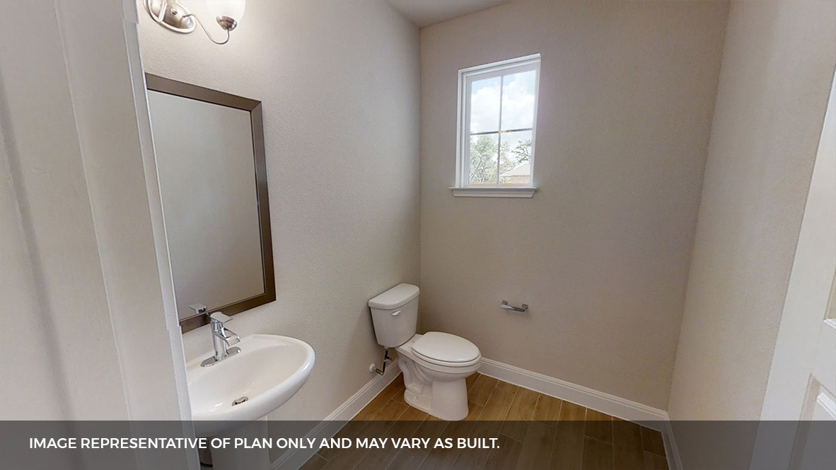 516 Prairie Wind Drive Leander, TX 78641 - Photo 15 of 40 a white toilet sitting next to a bathroom sink